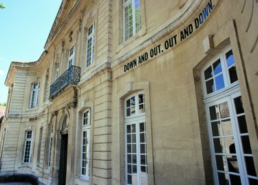 Lawrence Weiner, DOWN AND OUT, OUT AND DOWN, 1971, lettrage adhésif. Photographie Franck Couvreur, vue de la façade de l'hôtel de Caumont. Lawrence Weiner, DOWN AND OUT, OUT AND DOWN, 1971, lettrage adhésif. Photographie Franck Couvreur, vue de la façade de l'hôtel de Caumont.